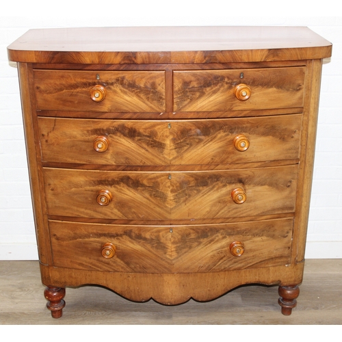 181 - A Victorian flame mahogany bow fronted two over three chest of drawers with bun handles and turned f... 
