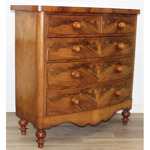 181 - A Victorian flame mahogany bow fronted two over three chest of drawers with bun handles and turned f... 