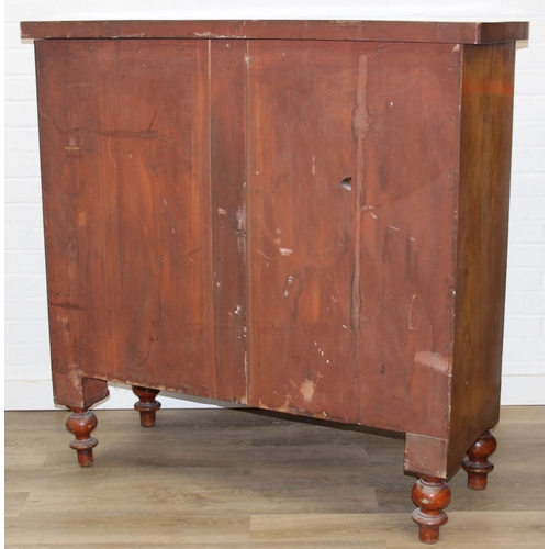 181 - A Victorian flame mahogany bow fronted two over three chest of drawers with bun handles and turned f... 