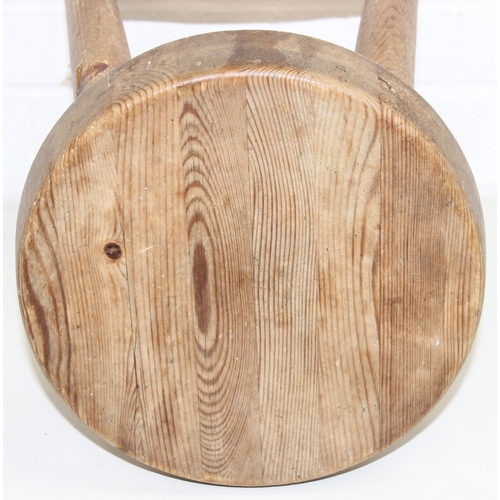 56 - Two rustic pine low stools, each 46cm tall
