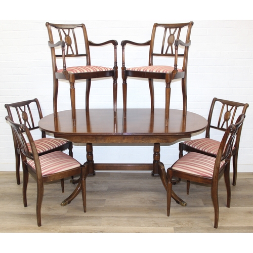 89 - A Georgian style mahogany dining table with brass paw feet and a set of six matching dining chairs, ... 