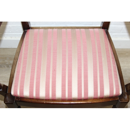 89 - A Georgian style mahogany dining table with brass paw feet and a set of six matching dining chairs, ... 