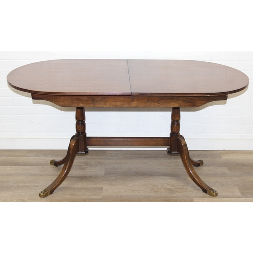 89 - A Georgian style mahogany dining table with brass paw feet and a set of six matching dining chairs, ... 