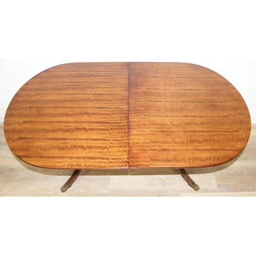 89 - A Georgian style mahogany dining table with brass paw feet and a set of six matching dining chairs, ... 