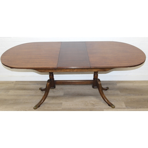 89 - A Georgian style mahogany dining table with brass paw feet and a set of six matching dining chairs, ... 