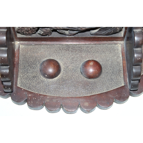 285 - An antique wall-mountable wooden shelf with central convex mirror and carved floral decoration, like... 