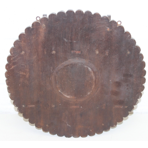 285 - An antique wall-mountable wooden shelf with central convex mirror and carved floral decoration, like... 