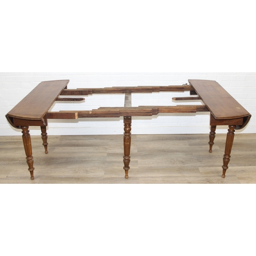 178 - A large extending Oak dining table with reeded supports and drop ends, 113cm x 62cm (raising to 116c... 