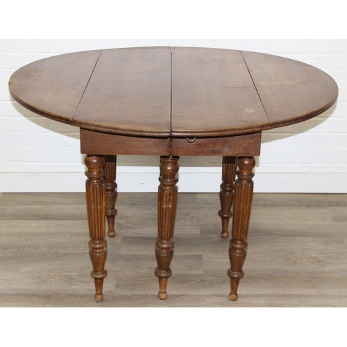 178 - A large extending Oak dining table with reeded supports and drop ends, 113cm x 62cm (raising to 116c... 