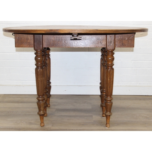 178 - A large extending Oak dining table with reeded supports and drop ends, 113cm x 62cm (raising to 116c... 