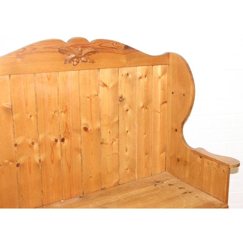 55 - A vintage pine settle or hall seat with storage box seat, carved details, 91cm x 43cm x 109cm