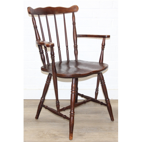 185 - A vintage farmhouse stickback armchair of unusual form, 86cm tall
