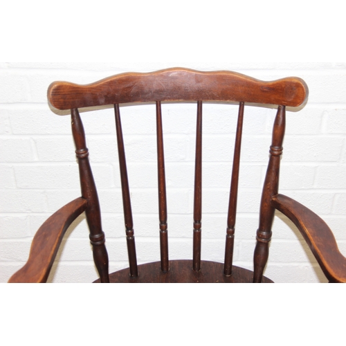 185 - A vintage farmhouse stickback armchair of unusual form, 86cm tall