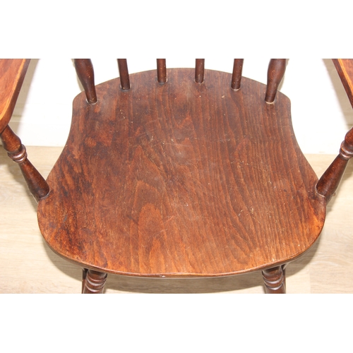 185 - A vintage farmhouse stickback armchair of unusual form, 86cm tall