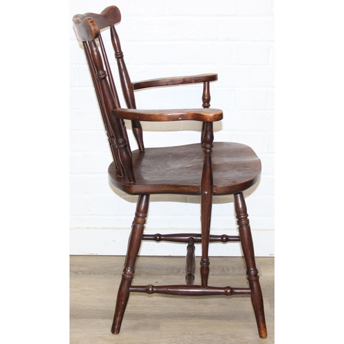 185 - A vintage farmhouse stickback armchair of unusual form, 86cm tall