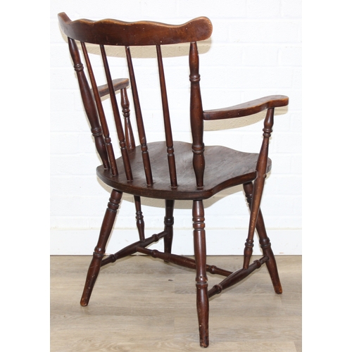 185 - A vintage farmhouse stickback armchair of unusual form, 86cm tall