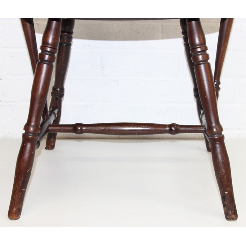 185 - A vintage farmhouse stickback armchair of unusual form, 86cm tall