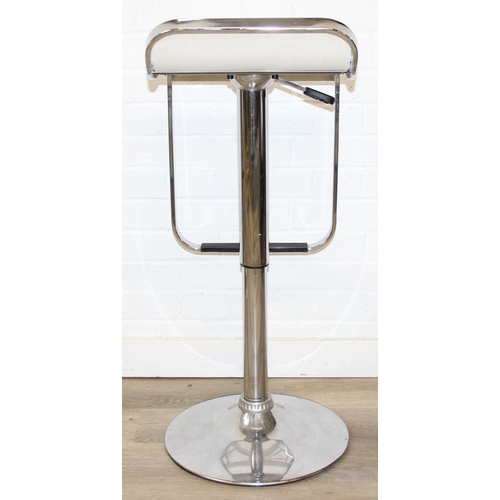 27 - A pair of retro style chrome and white leather effect bar stools by Dwell, in the manner of LEM stoo... 