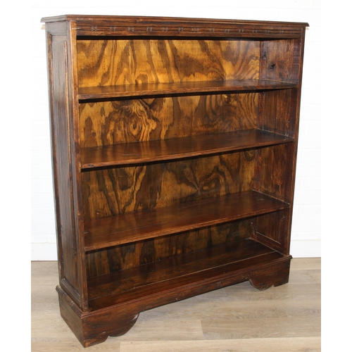 189 - A vintage bookcase with three shelves and panelled sides, unknown wood with prominent grain, possibl... 