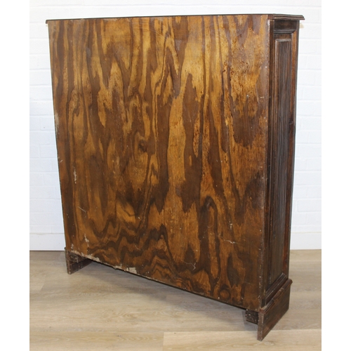 189 - A vintage bookcase with three shelves and panelled sides, unknown wood with prominent grain, possibl... 