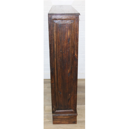 189 - A vintage bookcase with three shelves and panelled sides, unknown wood with prominent grain, possibl... 