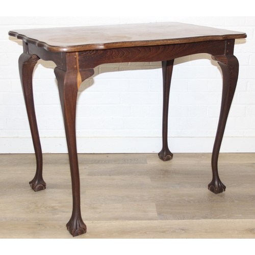 64 - A small wooden table with wavy edge and ball and claw feet, unknown wood with prominent grain, possi... 