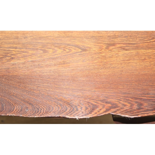 64 - A small wooden table with wavy edge and ball and claw feet, unknown wood with prominent grain, possi... 