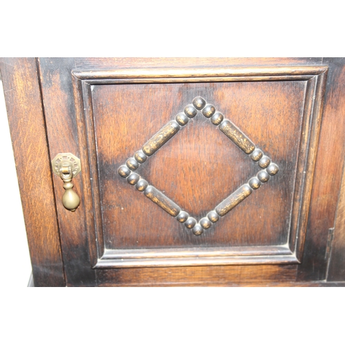 63 - A vintage oak cabinet with fitted interior for holding smoking pipes and a vintage wooden magazine r... 