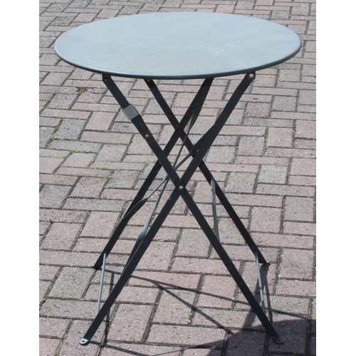312 - A folding metal bistro table and two folding chairs, the table 60cm in diameter