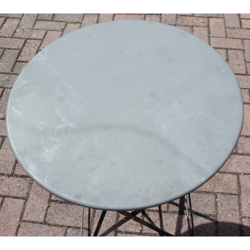 312 - A folding metal bistro table and two folding chairs, the table 60cm in diameter