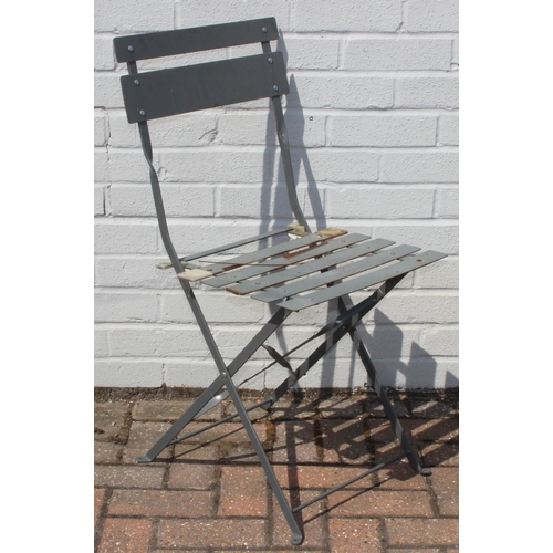 312 - A folding metal bistro table and two folding chairs, the table 60cm in diameter