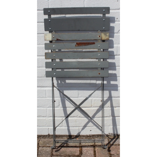 312 - A folding metal bistro table and two folding chairs, the table 60cm in diameter