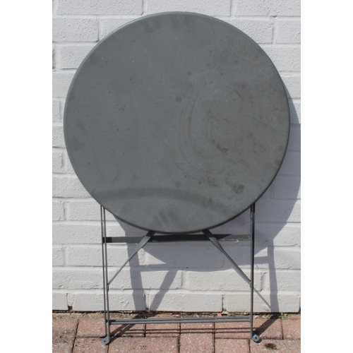 312 - A folding metal bistro table and two folding chairs, the table 60cm in diameter