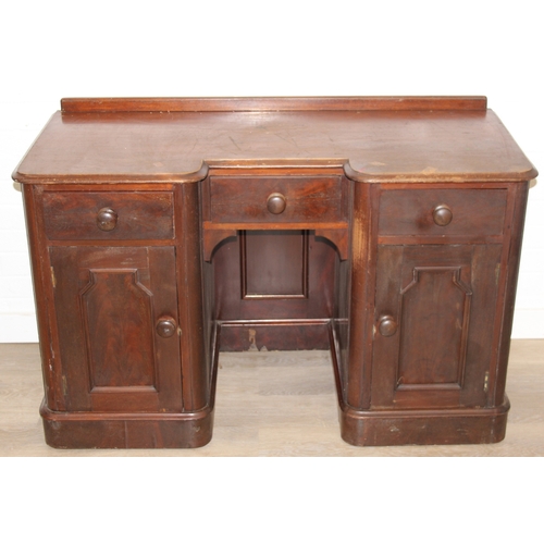94 - A 19th century mahogany desk with three drawers and two cupboards, approx 120cm x 54cm x 74cm