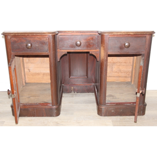 94 - A 19th century mahogany desk with three drawers and two cupboards, approx 120cm x 54cm x 74cm