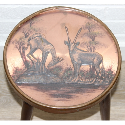 76 - A pair of vintage stools or side table with embossed copper tops showing scenes of African animals, ... 