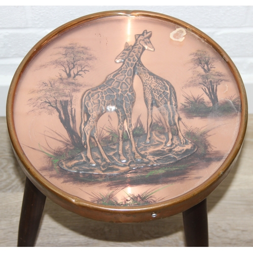76 - A pair of vintage stools or side table with embossed copper tops showing scenes of African animals, ... 