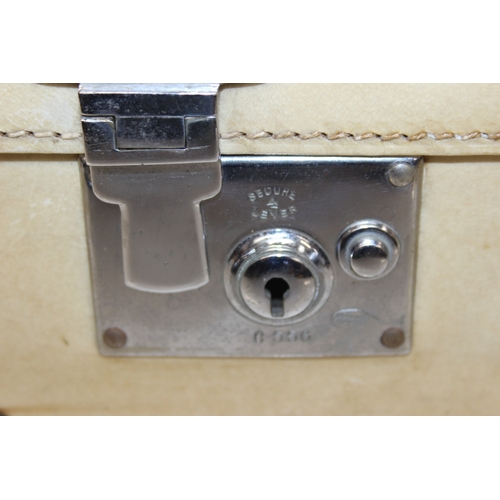 288 - A vintage vellum coloured suitcase by William Parks of Eastbourne, watered silk lined interior, with... 