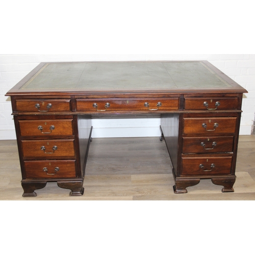 186 - A vintage mahogany partner's three-part pedestal desk with inset green leather top, eighteen drawers... 