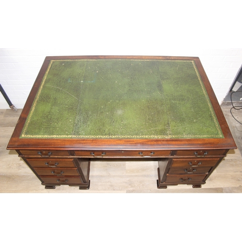 186 - A vintage mahogany partner's three-part pedestal desk with inset green leather top, eighteen drawers... 