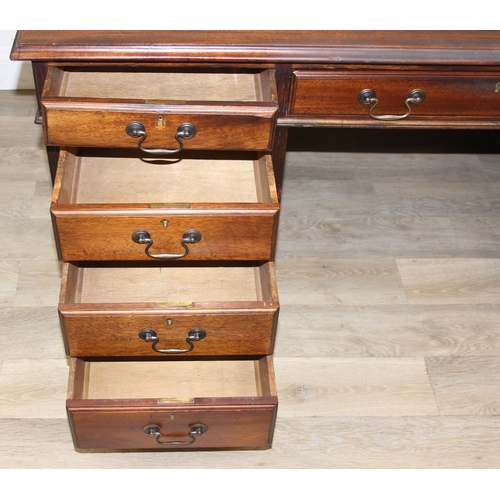 186 - A vintage mahogany partner's three-part pedestal desk with inset green leather top, eighteen drawers... 