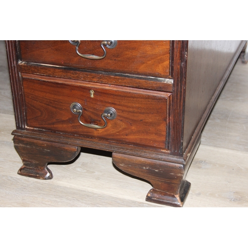 186 - A vintage mahogany partner's three-part pedestal desk with inset green leather top, eighteen drawers... 