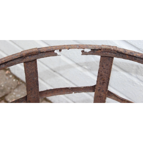 313 - A large vintage glass carboy in iron basket, 52cm in diameter x 62cm tall