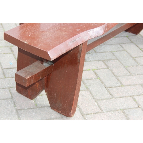 315 - A rustic stained wooden garden bench, two plank construction, 153cm wide