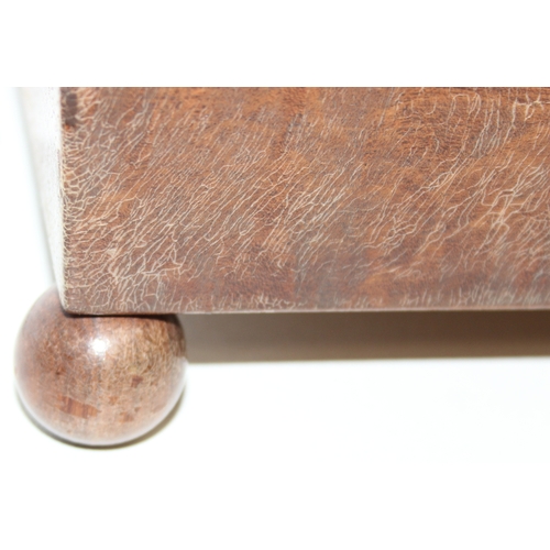 293 - An antique mahogany sarcophagus tea caddy with turned feet and ring handles, three compartment inter... 