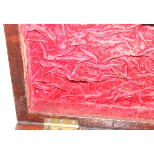 293 - An antique mahogany sarcophagus tea caddy with turned feet and ring handles, three compartment inter... 