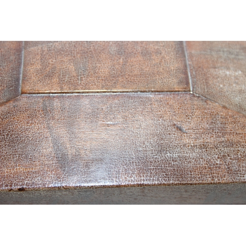 293 - An antique mahogany sarcophagus tea caddy with turned feet and ring handles, three compartment inter... 