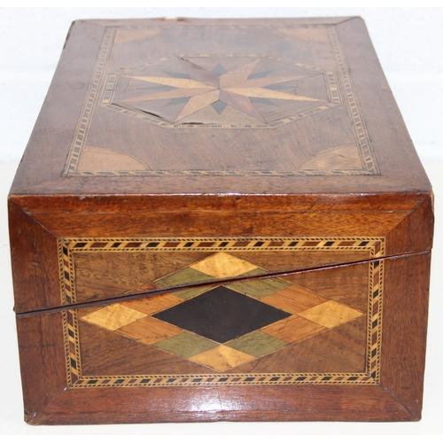 292 - A Victorian parquetry wooden writing slope with geometric marquetry inlaid details, blue velvet lini... 