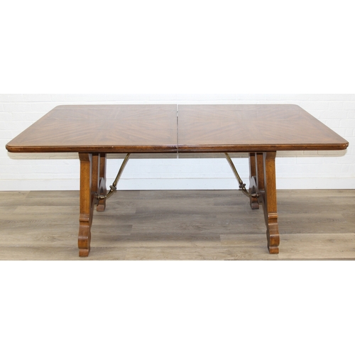 86 - An early 20th century walnut extending dining table with decorative Spanish Baroque style base, with... 