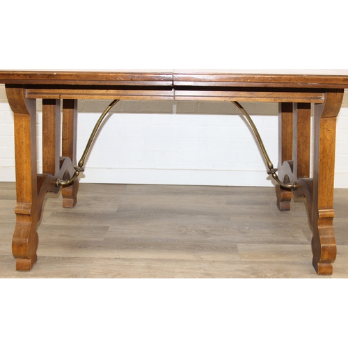86 - An early 20th century walnut extending dining table with decorative Spanish Baroque style base, with... 